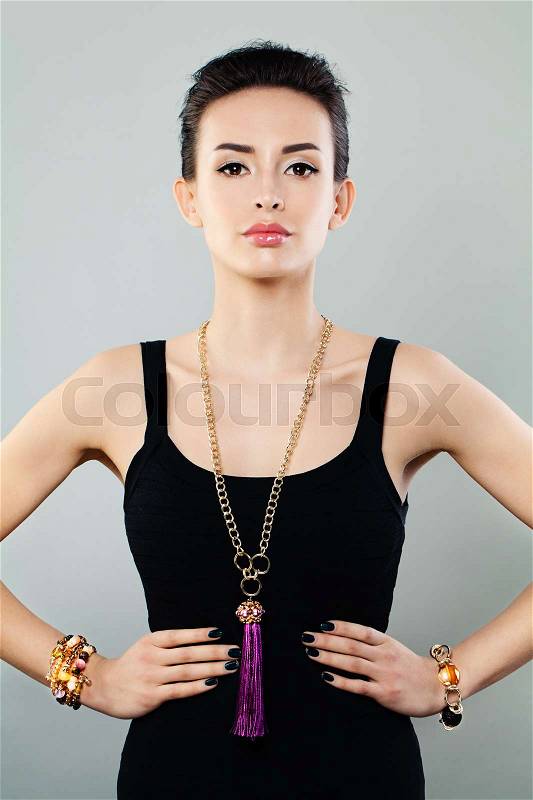 Fashion Portrait of Glamorous Model Woman with Gold Necklace and Bracelet, stock photo