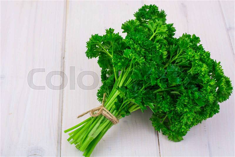 Bunch of fresh parsley on white boards, top view. Studio Photo, stock photo