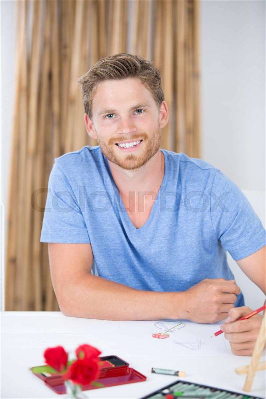 Portrait of young man drawing still life, stock photo