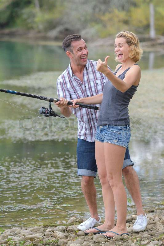 Happy couple fishing, stock photo
