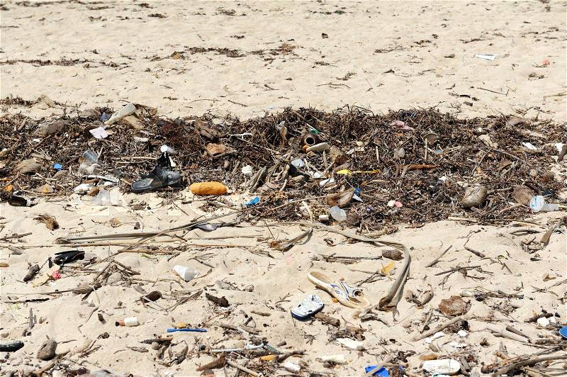 Trash on beach. Waste on the sands causes environmental pollution, stock photo