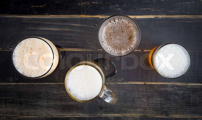 Beer glasses with various beer on old wood table,top view, stock photo