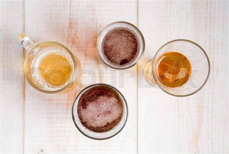 Beer glasses with various beer on wood table,top view, stock photo
