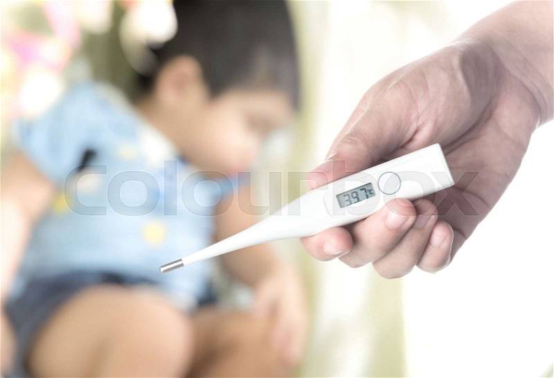 Holding electronic thermometer on background of sick children, stock photo