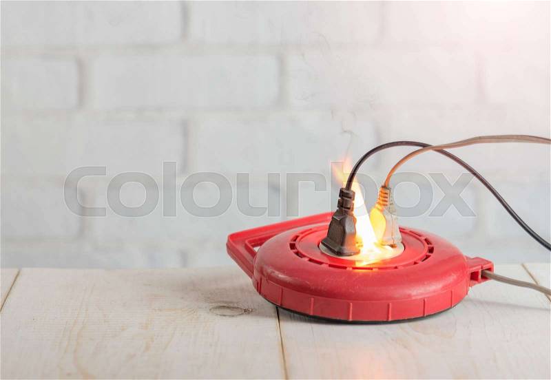 Electricity short circuit,Fire in overloaded power strip, stock photo