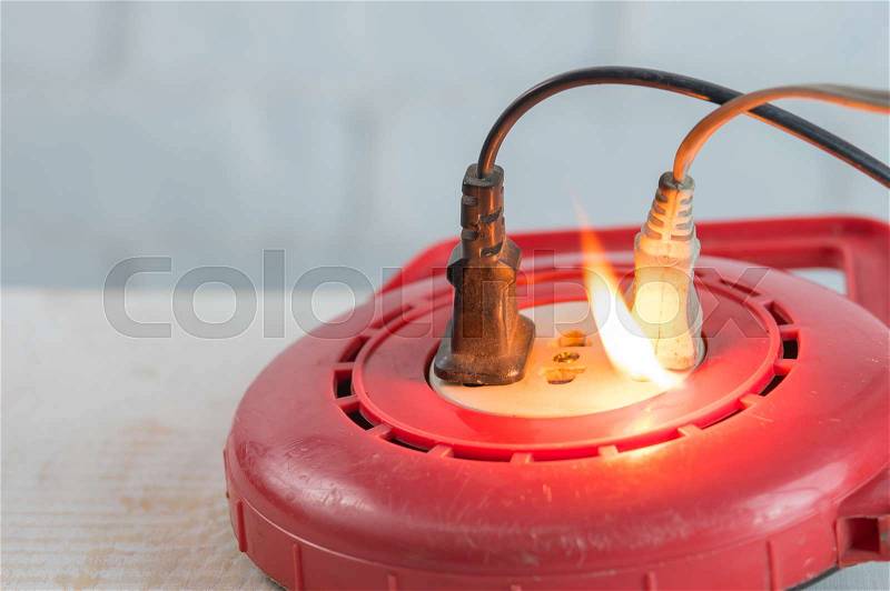 Electricity short circuit,Fire in overloaded power strip, stock photo