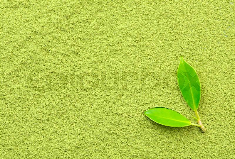 Background of green powder with tea leaves, stock photo