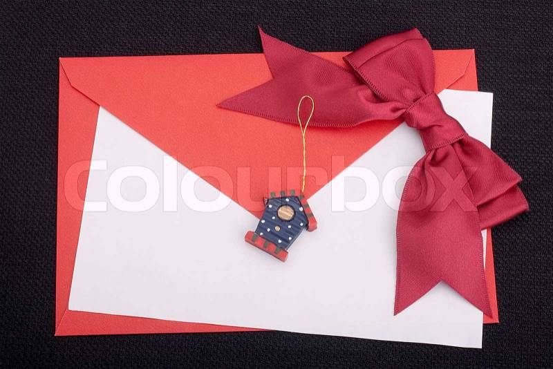 Congratulatory letter with a red envelope and a scarlet ribbon, stock photo