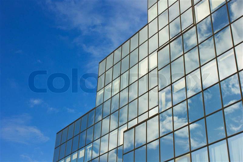 Sky and skyscraper building with reflection of sky and clouds, stock photo