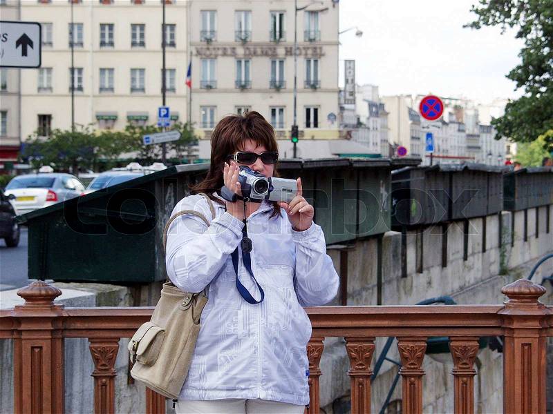 Woman tourist shoots video, stock photo