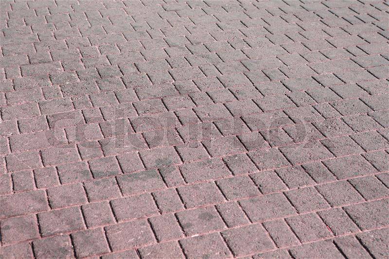 Pink brick paving stones on a sidewalk background texture, stock photo