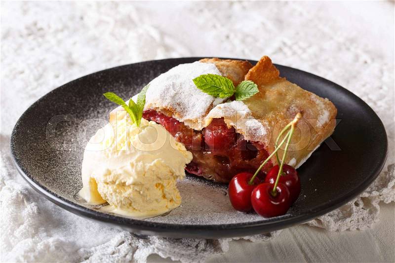 Healthy cherry strudel and vanilla ice cream close-up on a plate. Horizontal , stock photo