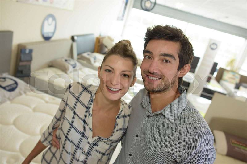 Couple posing in the bed shop, stock photo