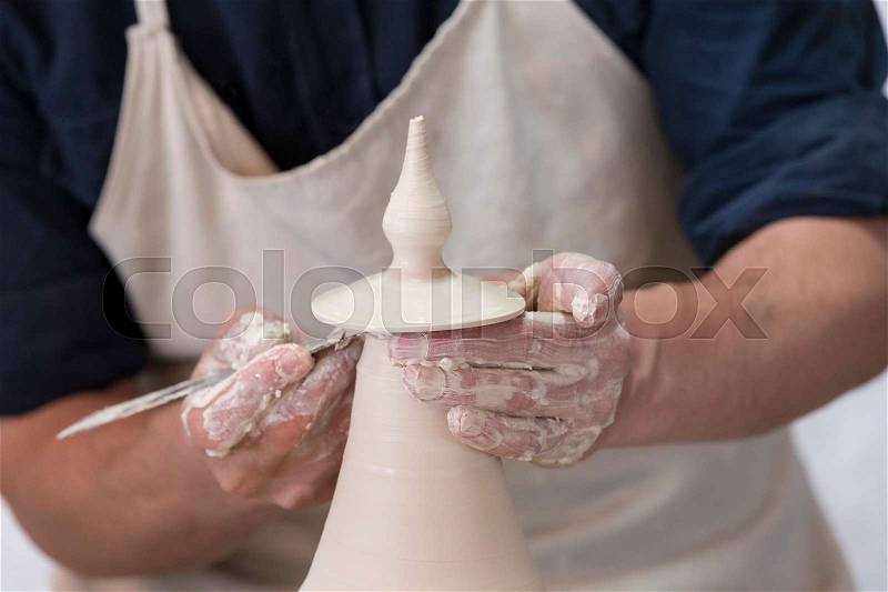 Hands of a potter in the period of work on the production of clay products, stock photo