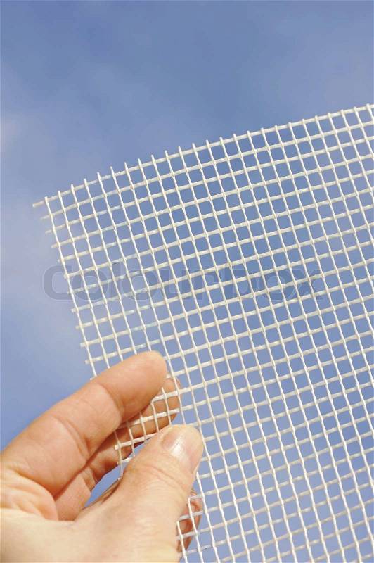 Detail of glass-fiber mesh in hand – reinforcing material for insulation, stock photo