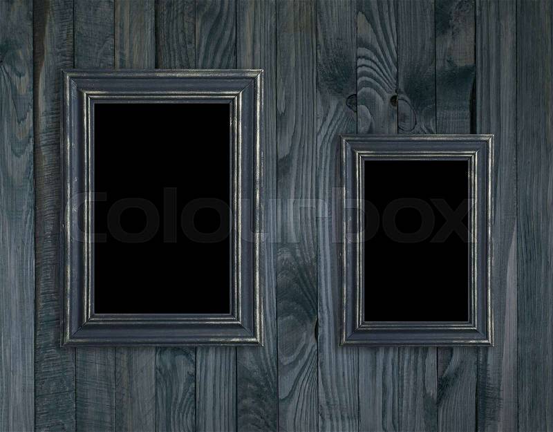 Vintage photo frames on wooden plank wall in retro style, stock photo