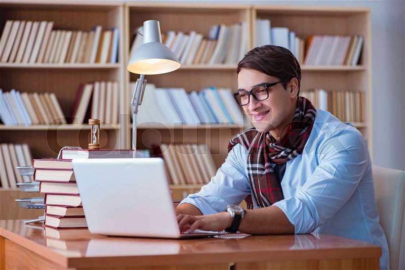 Young book writer writing in library, stock photo