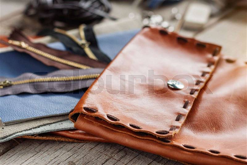Bag and accessories of leather repairing on wood, stock photo