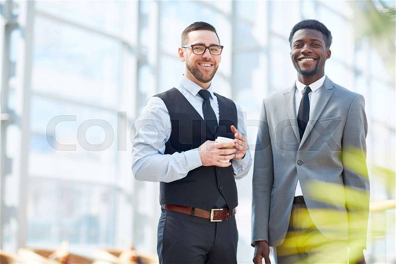 Intercultural men in formalwear looking at camera, stock photo