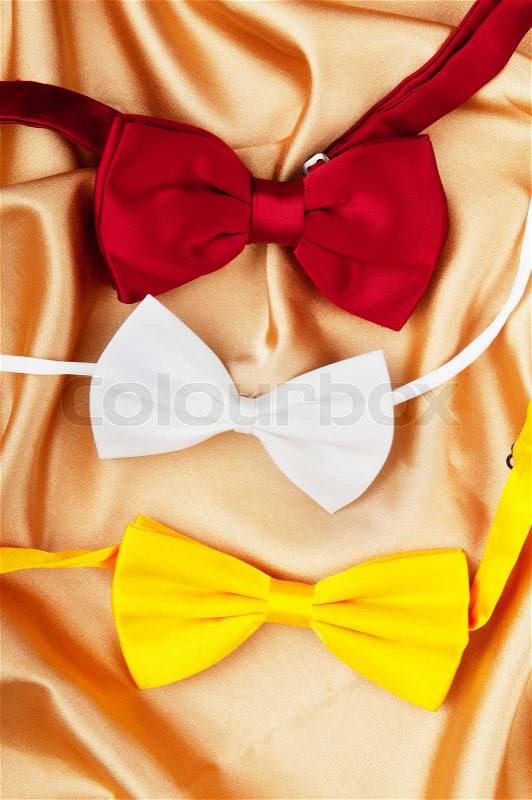 Bow ties on the bright satin background, stock photo
