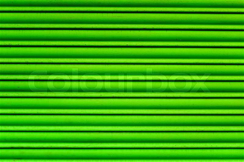 Closeup of a worn green garage roller door, stock photo