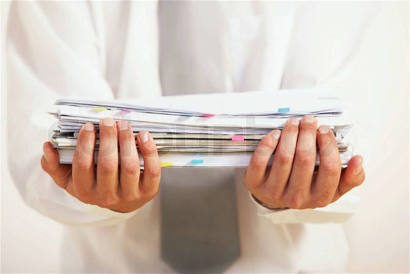 A businessman is holding the document, stock photo