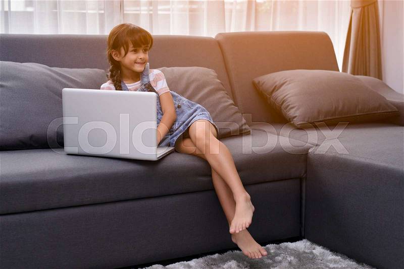 Beautiful girl travel to social media in living room, stock photo