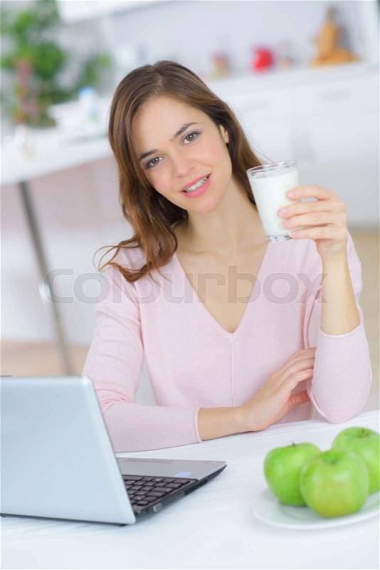 Young woman drinks milk, stock photo