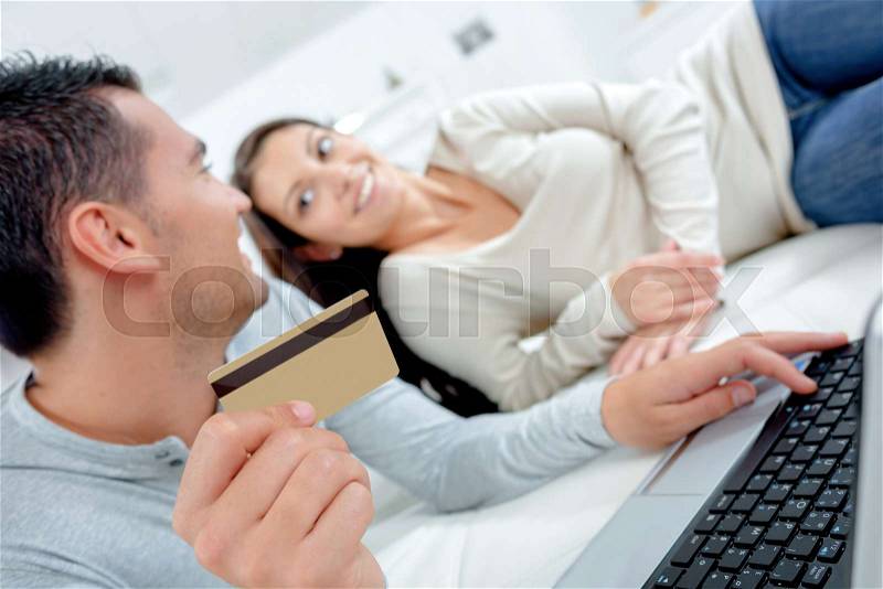 Couple buying something on internet with credit card, stock photo