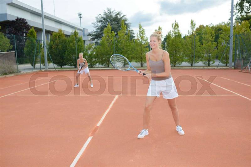 Two tennis player playing doubles at tennis court, stock photo