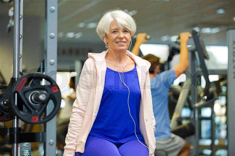 Senior lady working out in the gym, stock photo