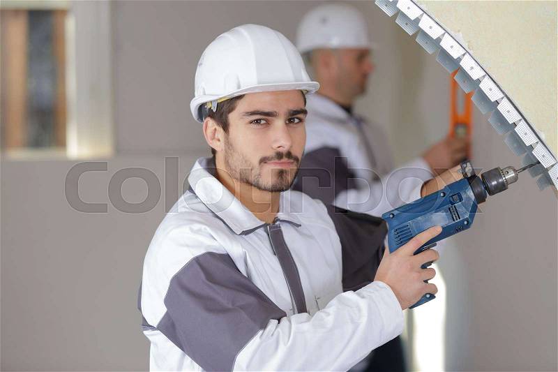 Young man with a drill, stock photo