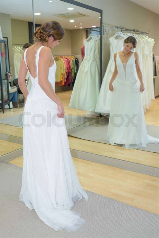 Bride trying on dress, stock photo