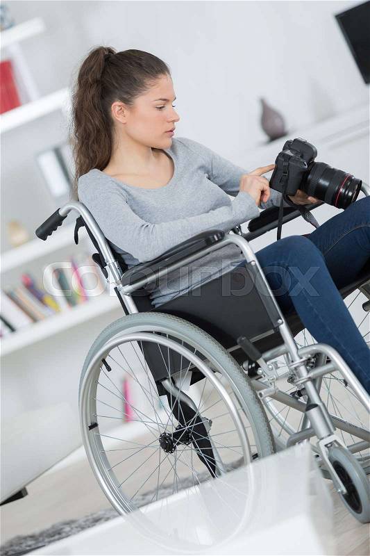 Disabled female photographer, stock photo