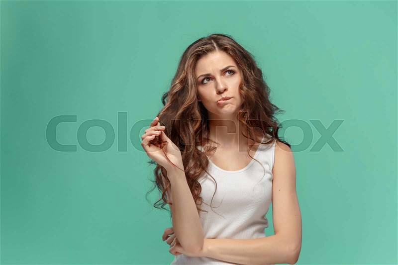 The young woman\'s portrait with sad emotions at studio, stock photo