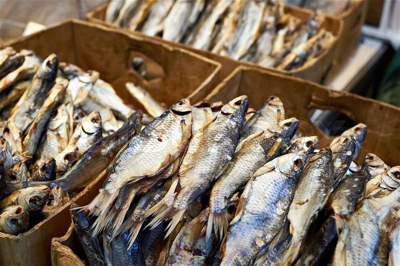 Dried fish in boxes on the market, stock photo