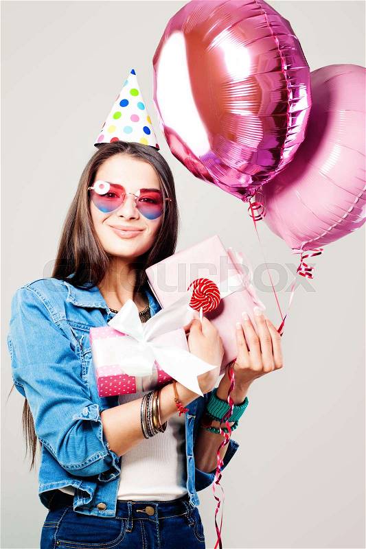 Pretty Girl with Gift Box. Holiday Portrait of Smiling Woman with Balloons and Gifts, stock photo