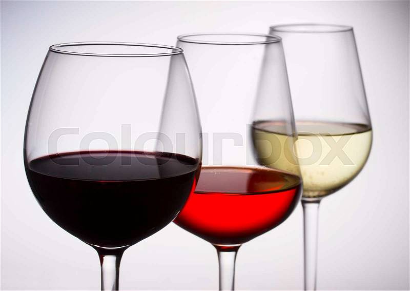 Set of three wine glasses with red, white and rose wine close up, stock photo