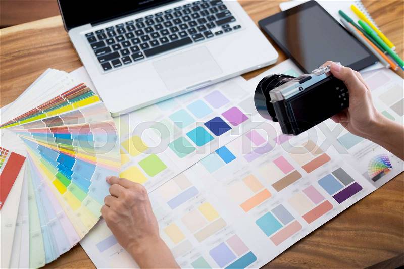 Interior design and renovation and technology concept - graphic designer choosing proper color samples for selection on table, stock photo