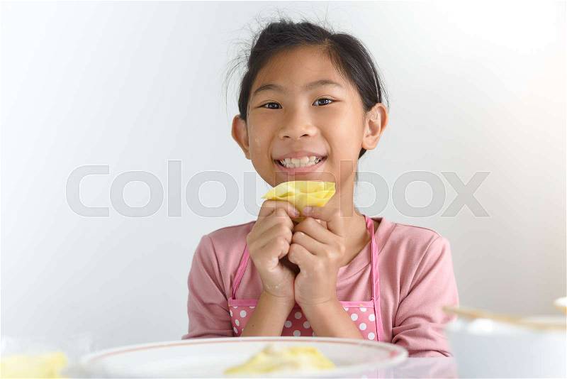 Asian girl leaning how to make manti (Central Asia dumplings), stock photo