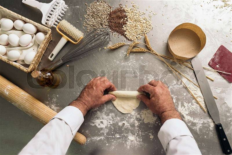 Baker kneading dough in a bakery. Bakery Concept, stock photo