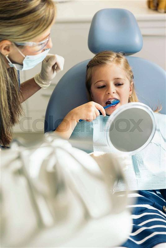 Doctor dentist teaching a child to brush teeth. Medical Concept, stock photo