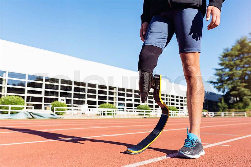 Close up disabled man athlete with leg prosthesis. Paralympic Sport Concept, stock photo