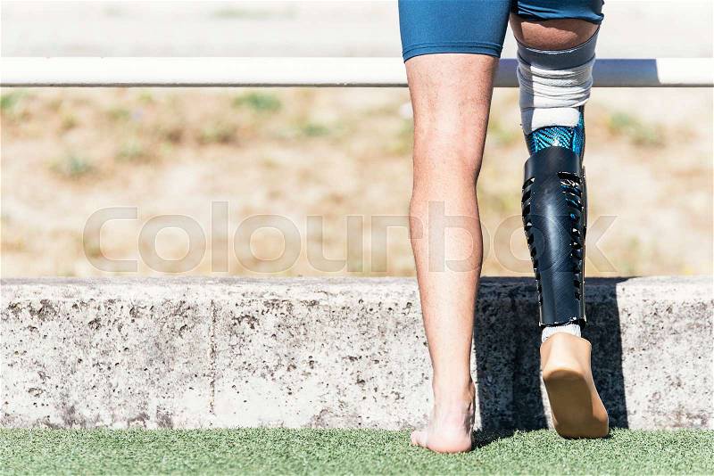 Close up disabled man athlete with leg prosthesis. Paralympic Sport Concept, stock photo