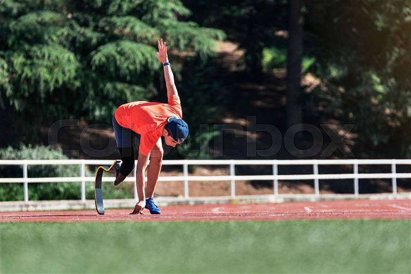 Disabled man athlete training with leg prosthesis. Paralympic Sport Concept, stock photo