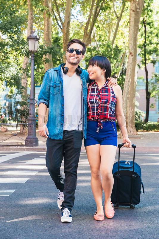 Tourist couple love walking in city with suitcase, stock photo