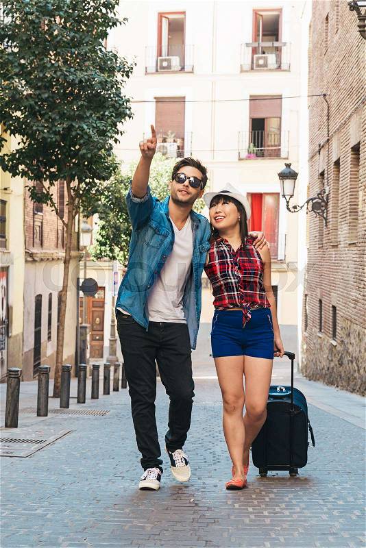 Tourist couple love walking in city with suitcase, stock photo