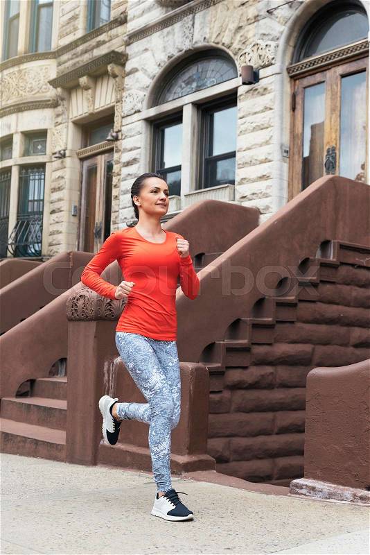 Young beautiful woman running on New York City, stock photo