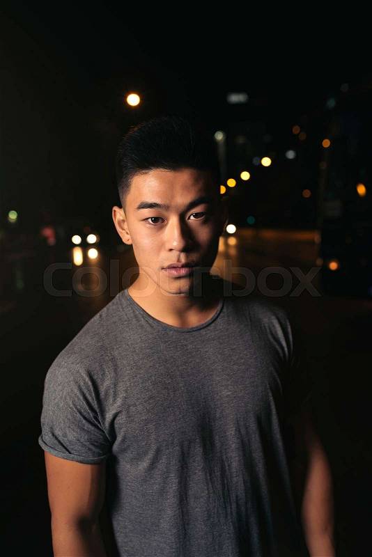 Portrait of a asian young man in the city, stock photo