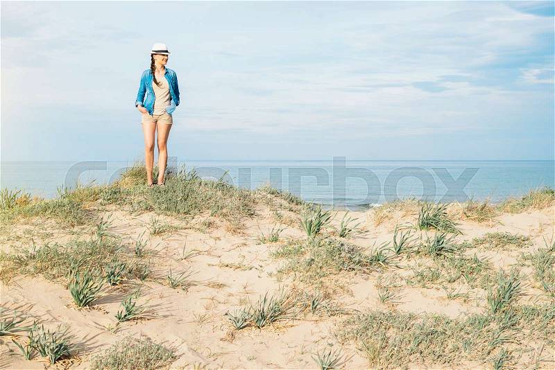 Pretty woman walking away on the idylic beach, stock photo